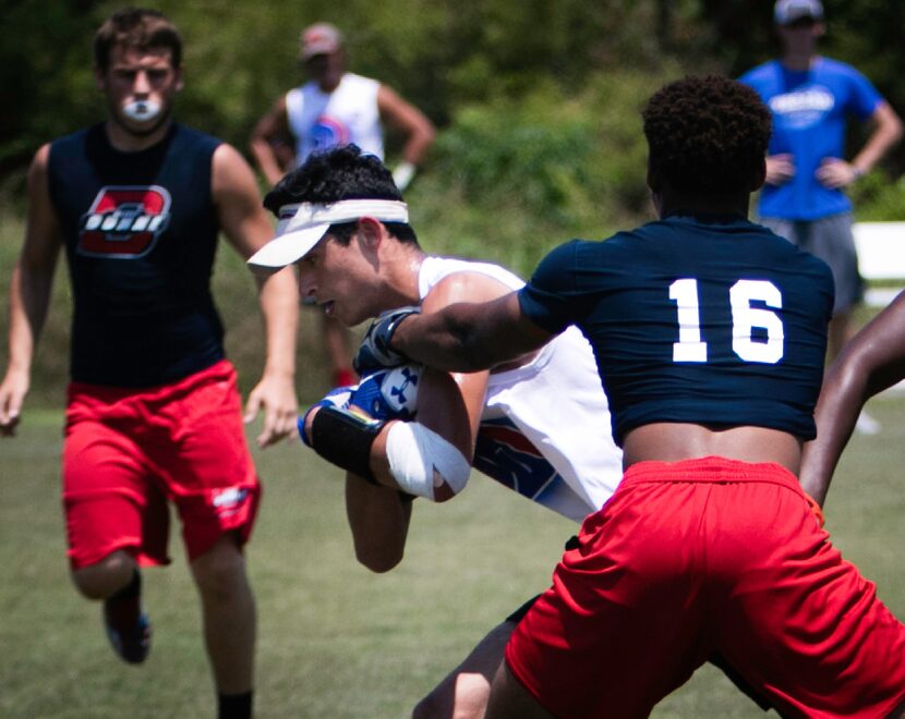 Trinity Christian Academy-Addison player Clarke Pino (center) pushes through Bishop Dunne...