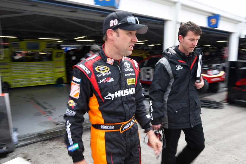 FILE - In this April 20, 2013 file photo, Matt Kenseth, left, walks from the garage...