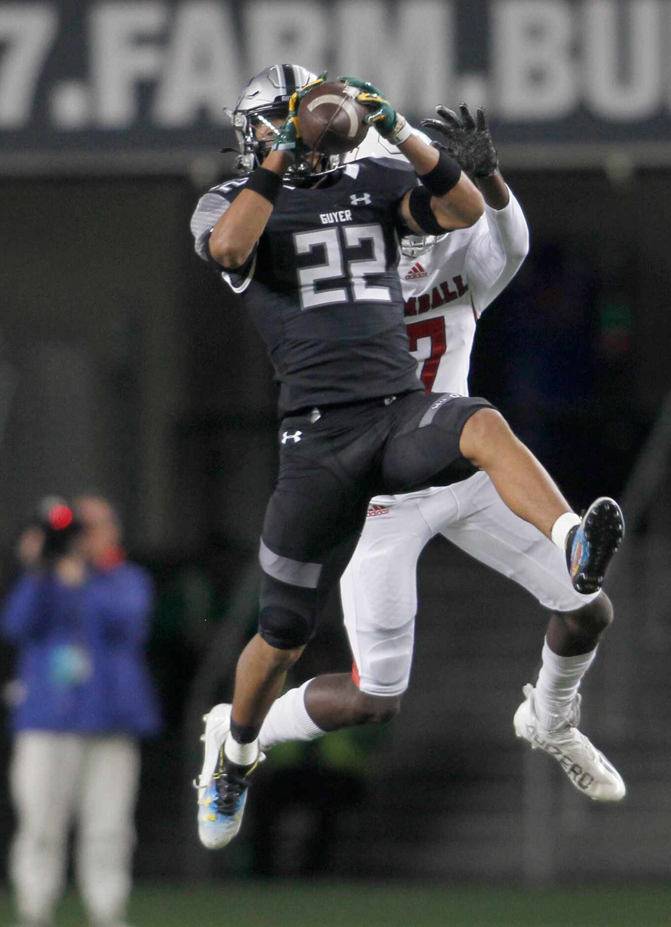 Denton Guyer defensive back Peyton Bowen (22) leaps to intercept a pass intended for Tomball...