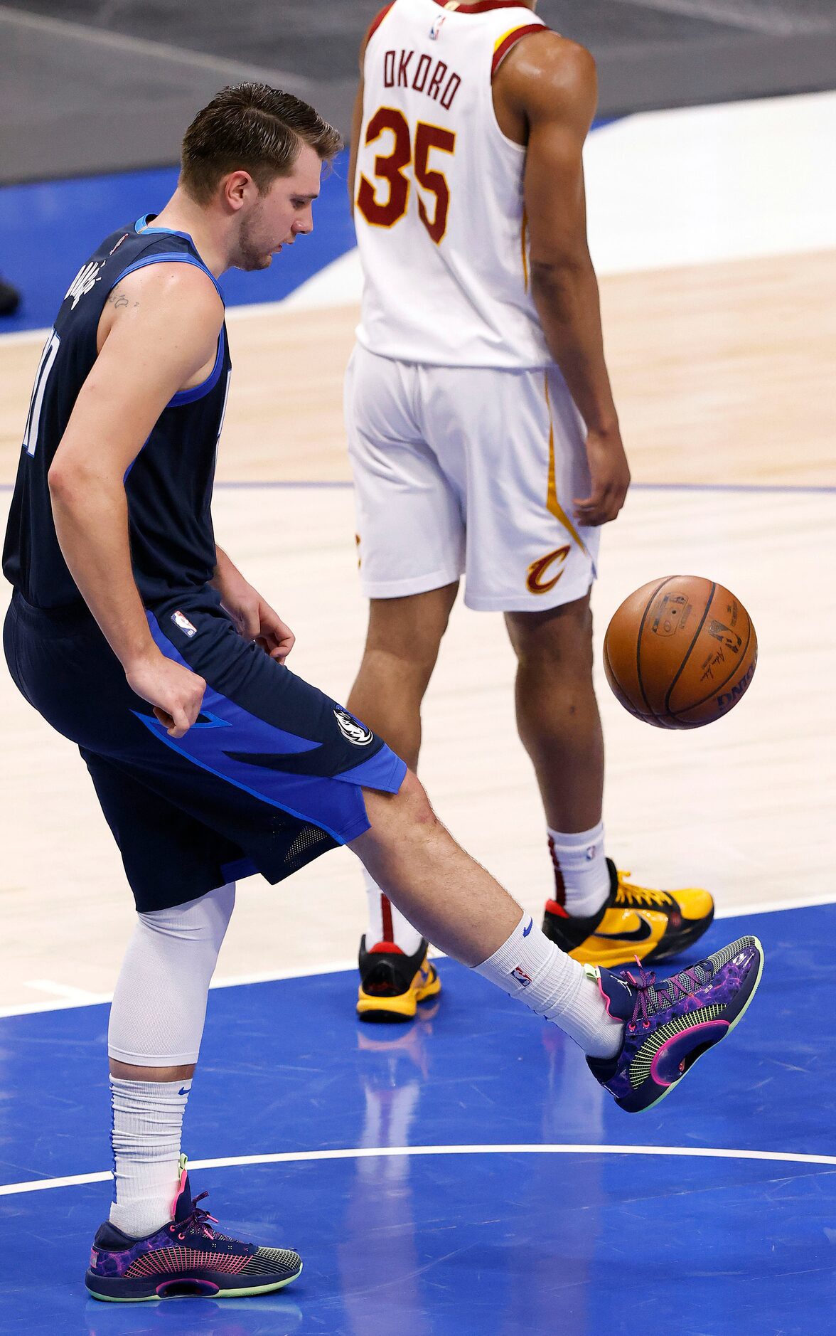 Dallas Mavericks guard Luka Doncic (77) kicks the ball soccer style as he picks it after...