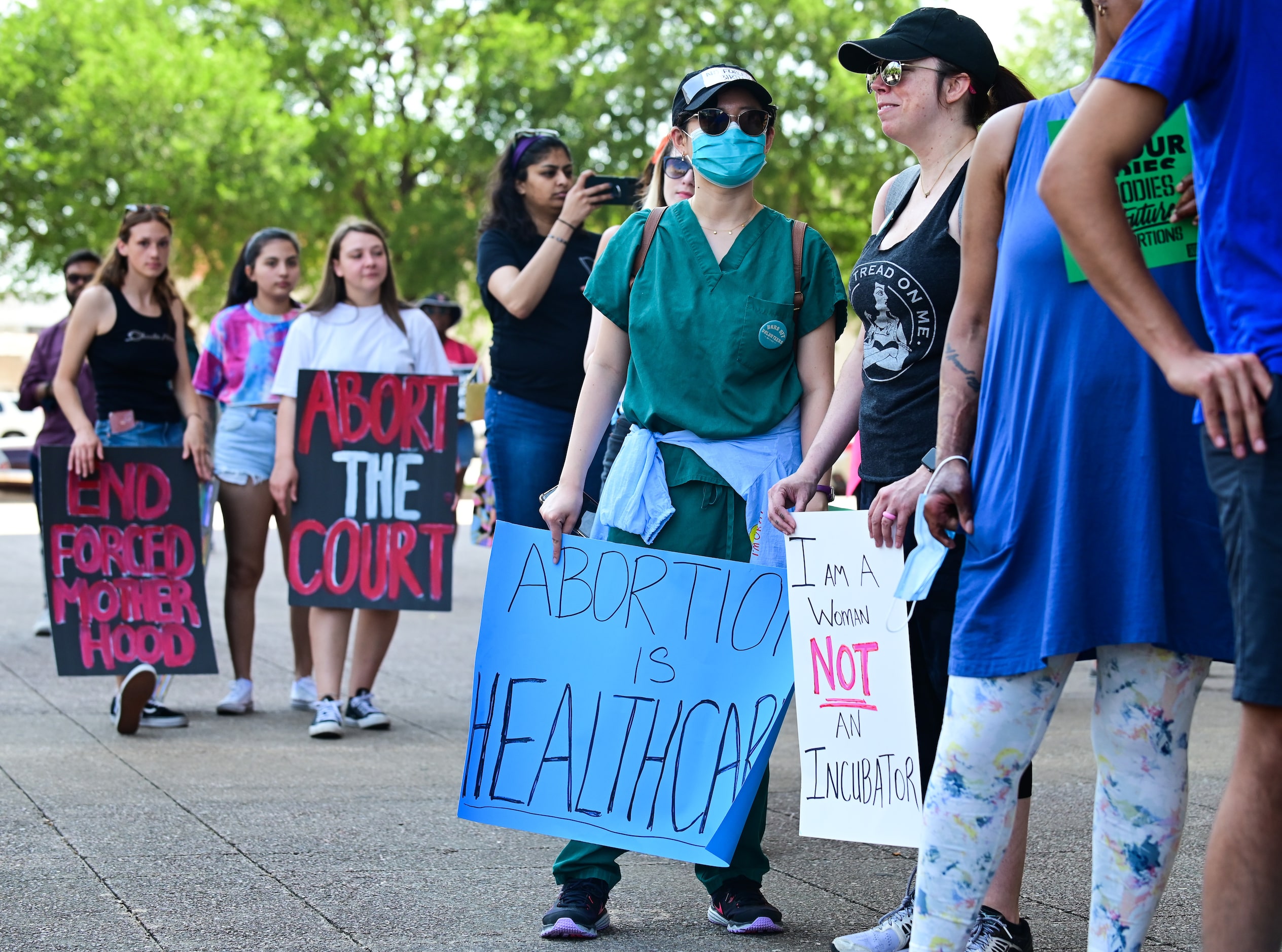 Emilie Nguyen, 28, center, and Heather Hall, 42, right, meet for the first time while...