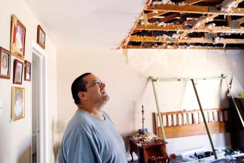 
Manuel Lopez pointed out the damage inflicted by the storm on his apartment on Northwest...