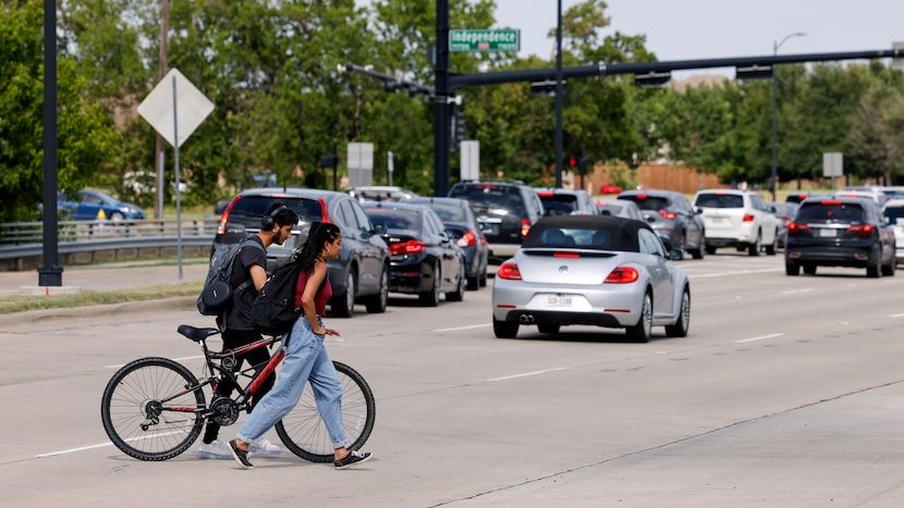 Students they cross the six lanes of Eldorado Parkway near Independence Parkway after the...