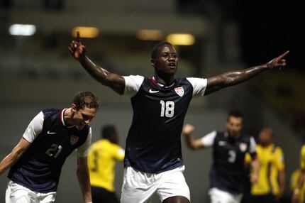 US Eddie Johnson, center, celebrates after scoring against Antigua and Barbuda during a 2014...