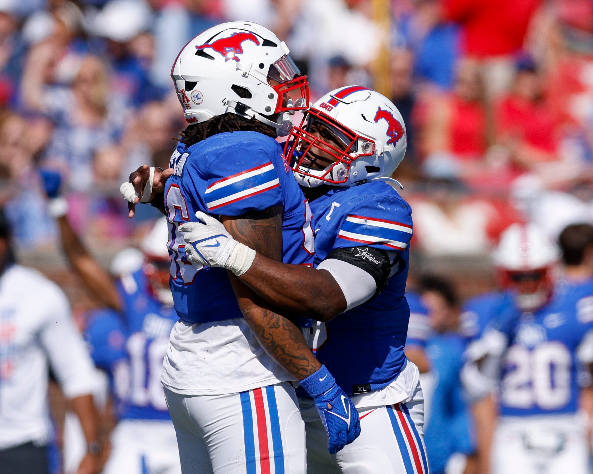 SMU defensive tackle DeVere Levelston (left) celebrates a sack with defensive tackle Elijah...