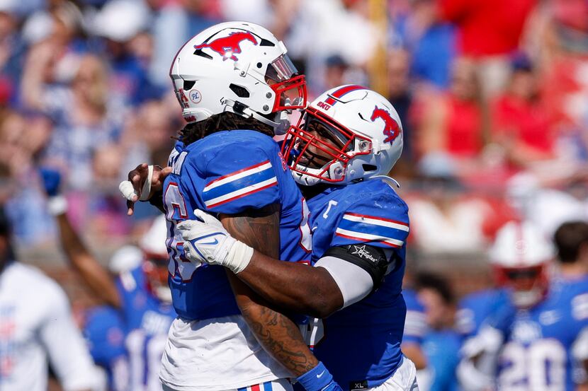 SMU defensive tackle DeVere Levelston (left) celebrates a sack with defensive tackle Elijah...