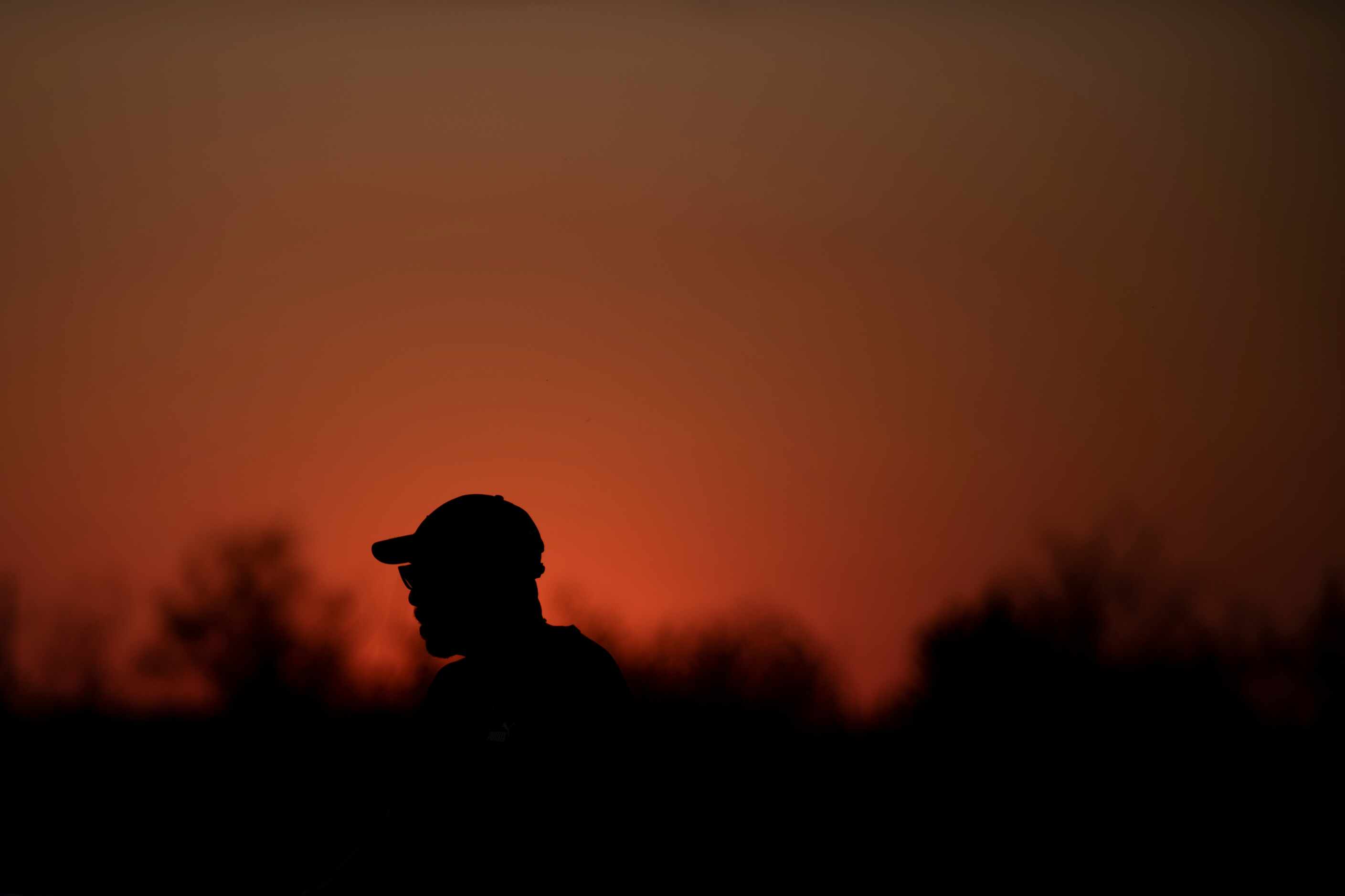 A fan watches kickoff during a high school football game between Carter and Lincoln at...