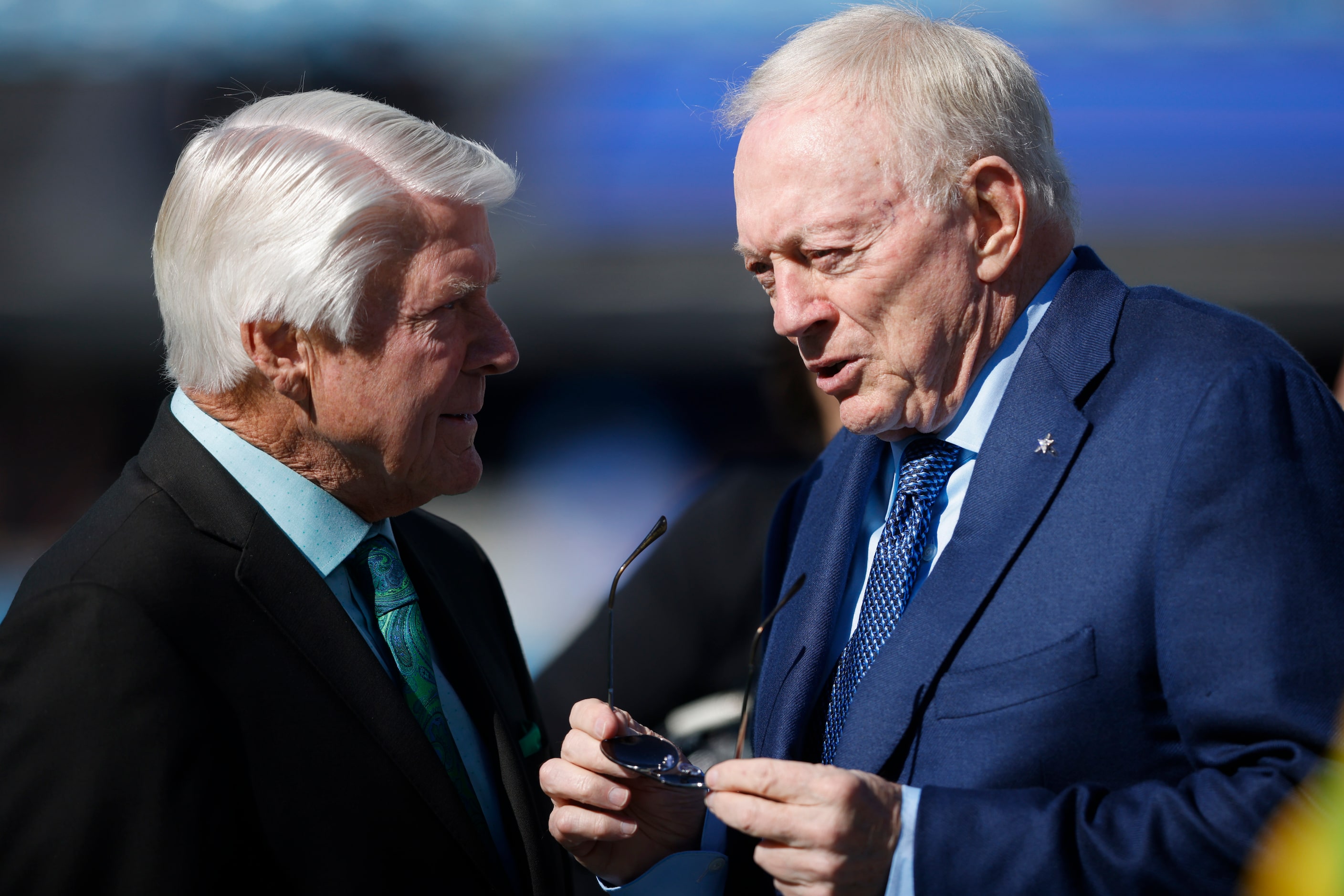 Pro Football Hall of Fame coach Jimmy Johnson chats with Cowboys owner Jerry Jones during...