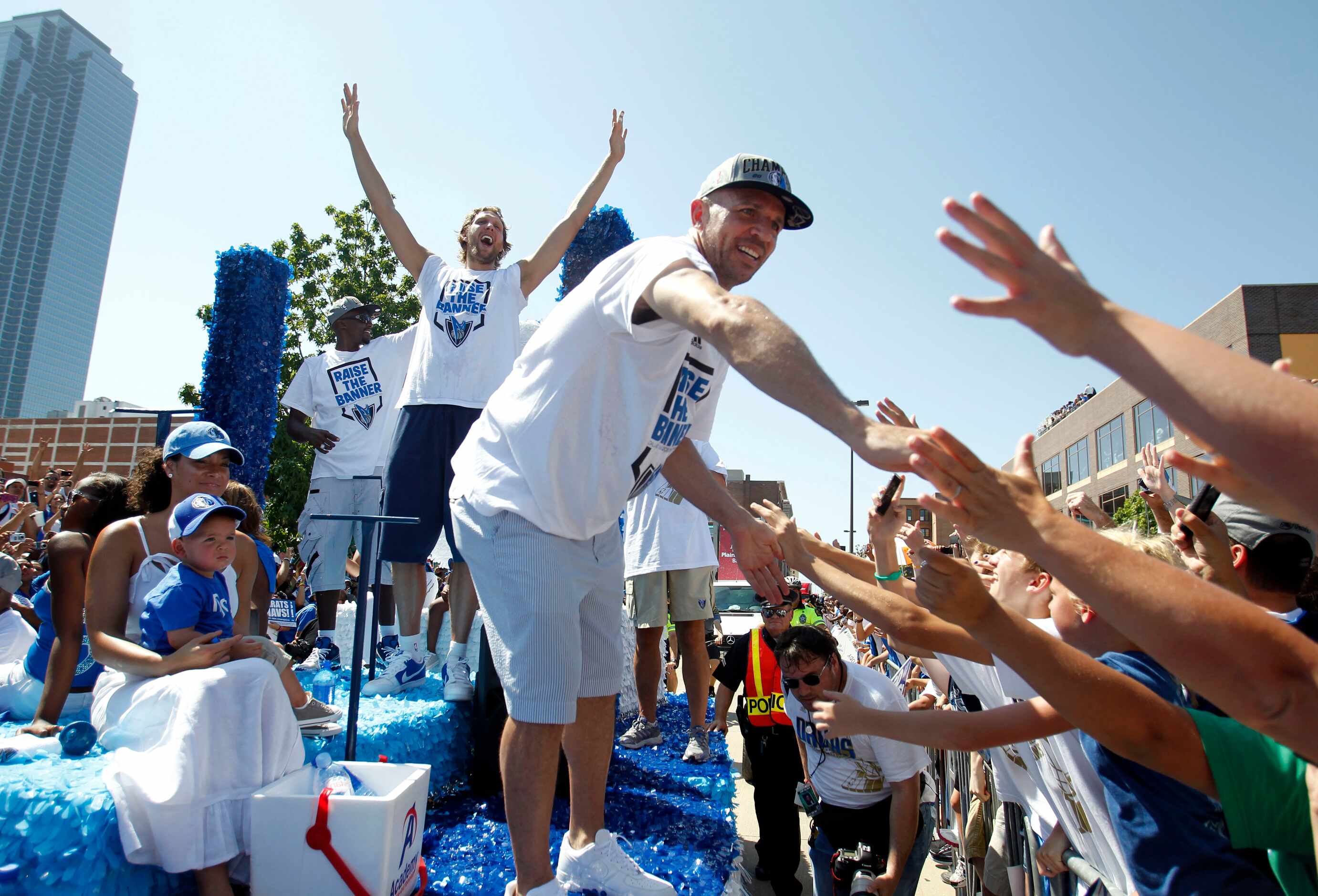 Dallas Mavericks point guard Jason Kidd (2) slaps hands with fans as Dallas Mavericks power...