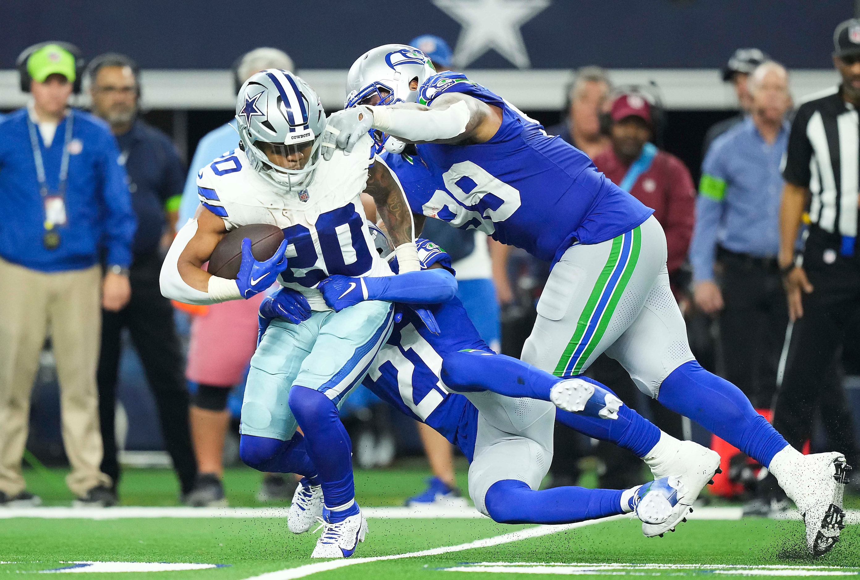 Dallas Cowboys running back Tony Pollard (20) is  brought down by Seattle Seahawks...