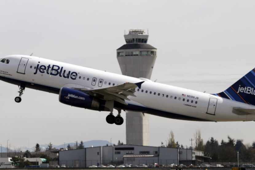 FILE - In this April 23, 2013, file photo, a JetBlue plane takes off in view of the air...