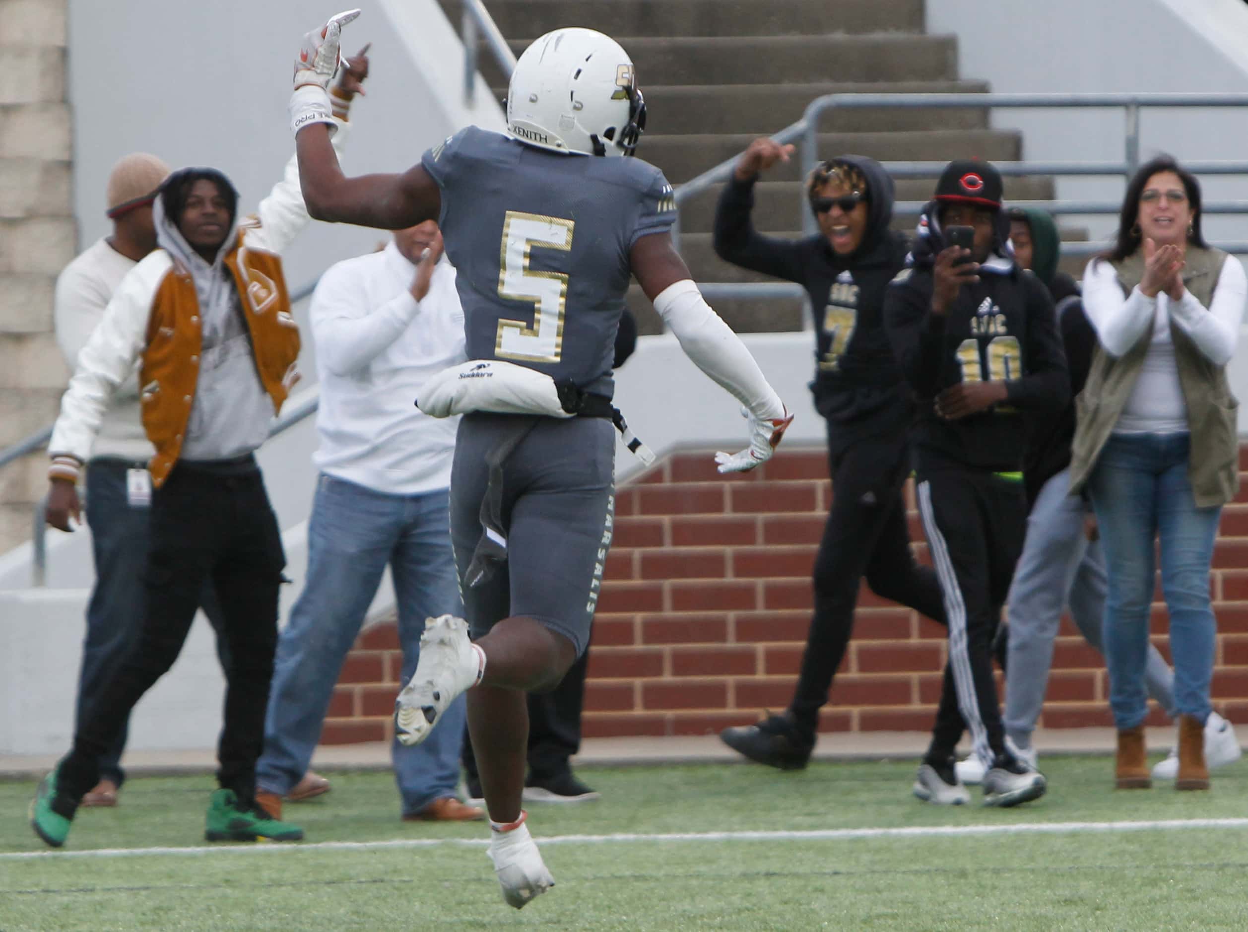 South Oak Cliff receiver Randy Reece (5) ignites fans after scoring the eventual winning...