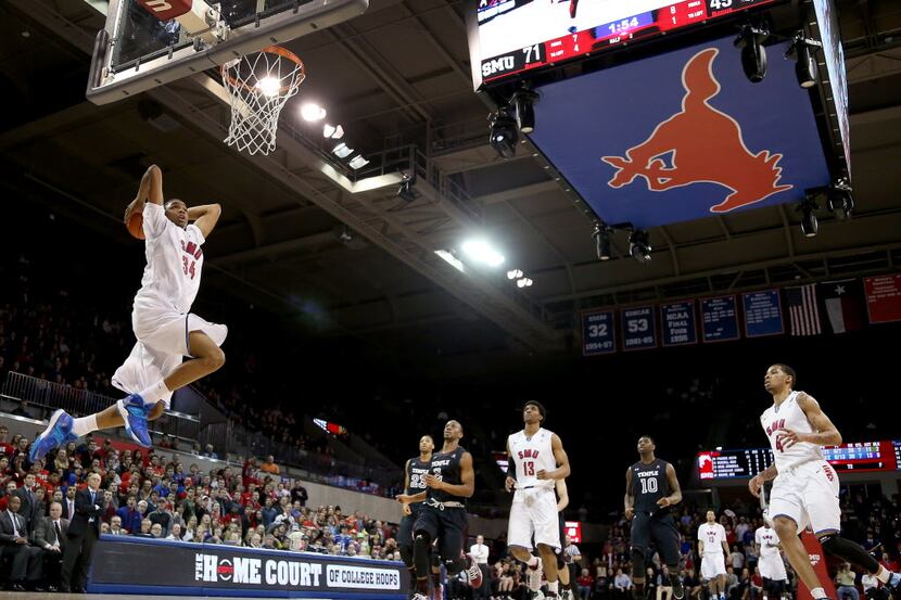 SMU Mustangs forward Ben Moore (34) goes up for a dunk against the Temple Owls in the second...