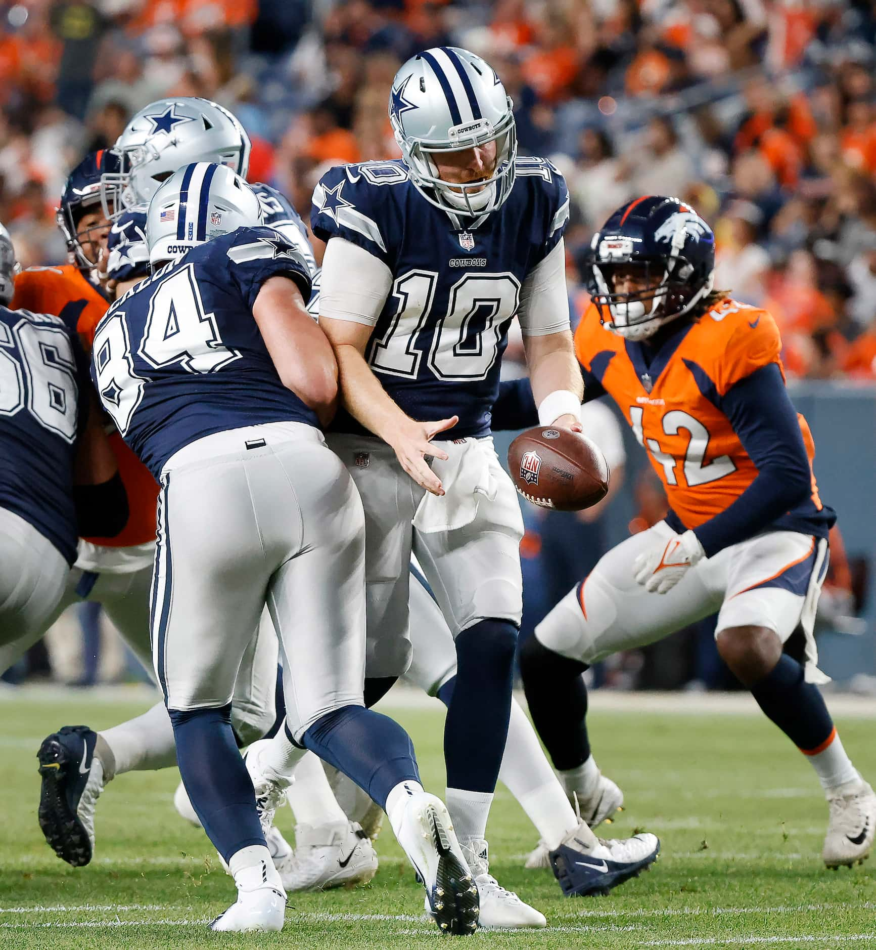 Dallas Cowboys tight end Sean McKeon (84) runs into quarterback Cooper Rush (10) as he...