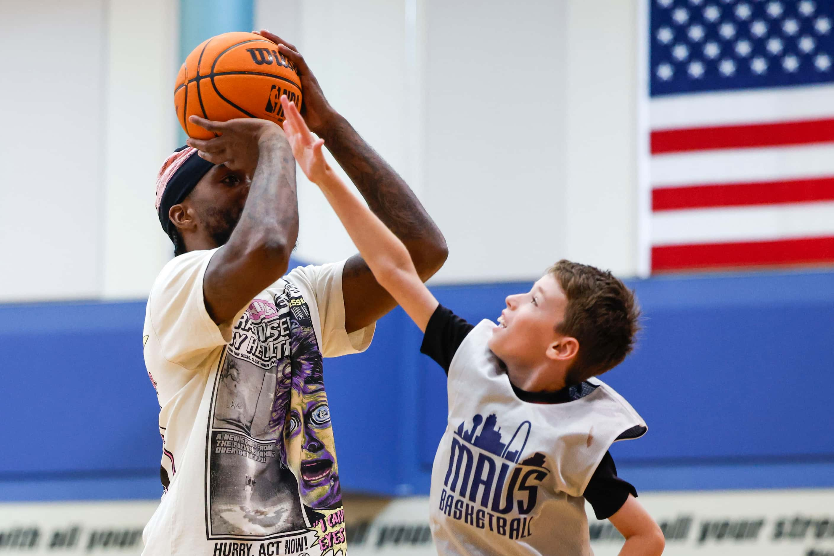 Dallas Mavericks’ Naji Marshall, play ball with young basketball campers during a Hoop Camp,...