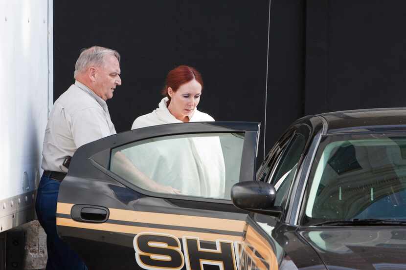 Shannon Richardson is placed into a Titus County Sheriff's car after an initial appearance...