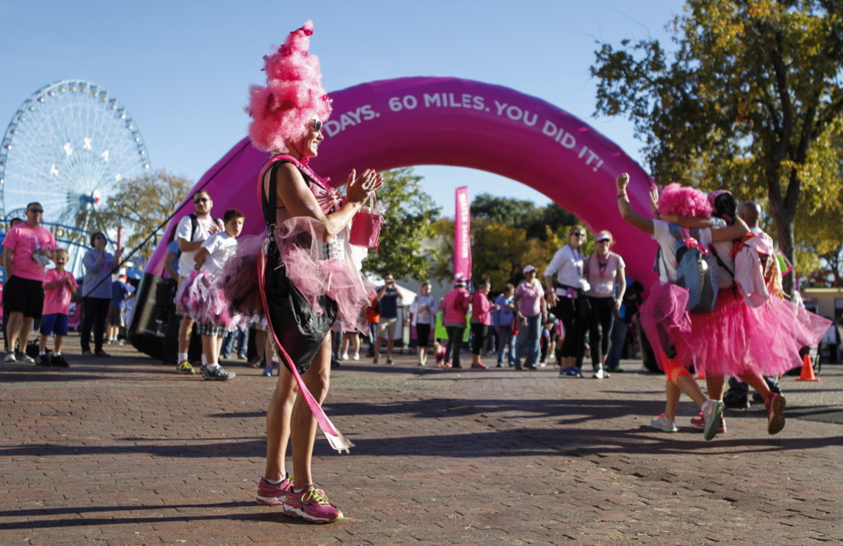 Perri Bickham of New Braunfels, Texas, applauds people at the finish like after complete her...