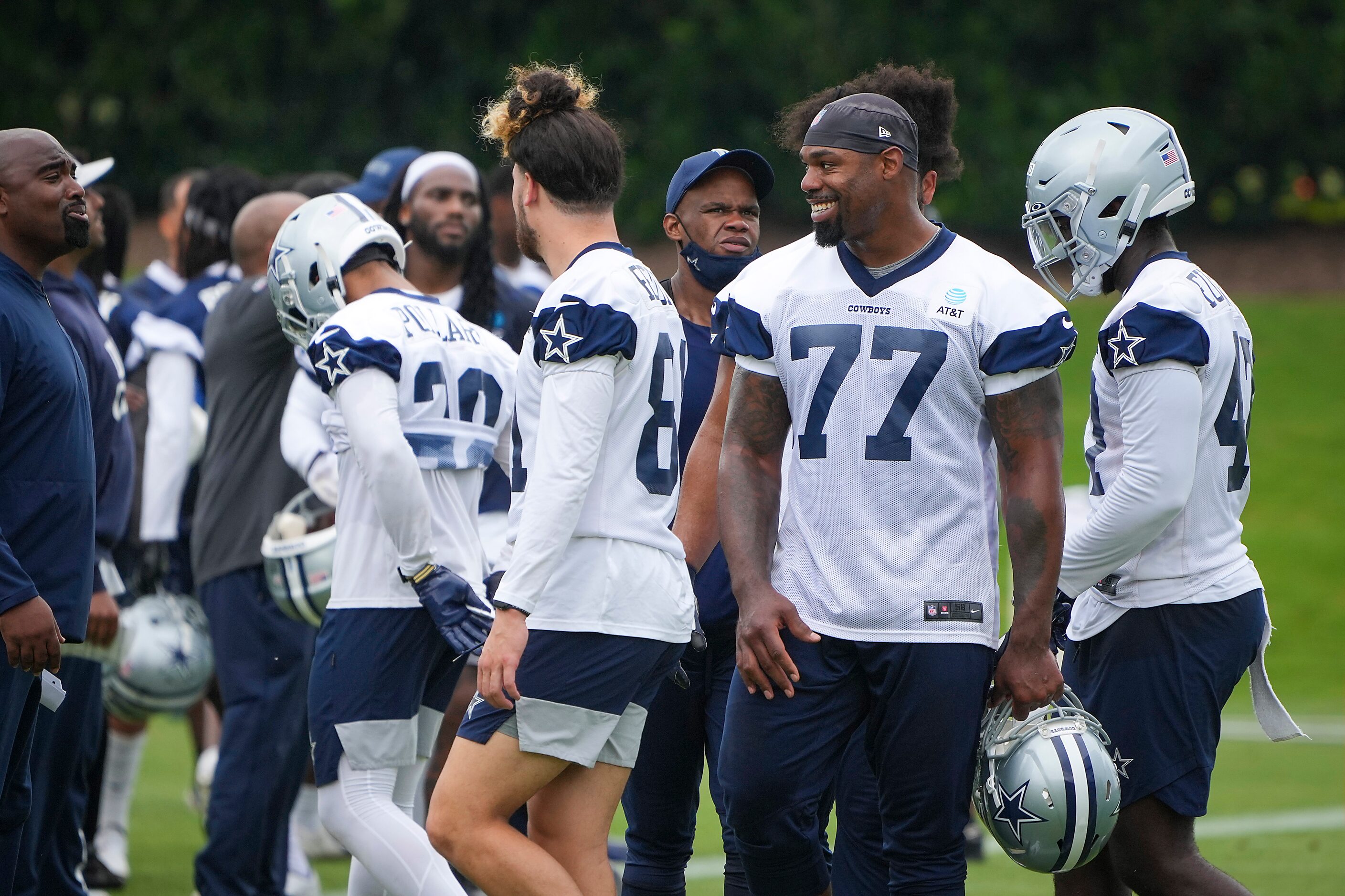 Dallas Cowboys tackle Tyron Smith (77) smiles on the sideline during a minicamp practice at...