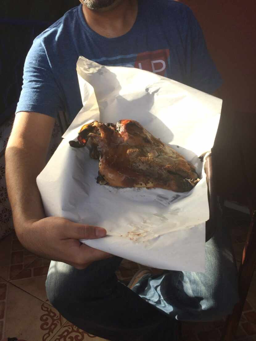 Our Marrakesh food tour guide, Youssef Mouttaki, holds the roasted sheep's head. 