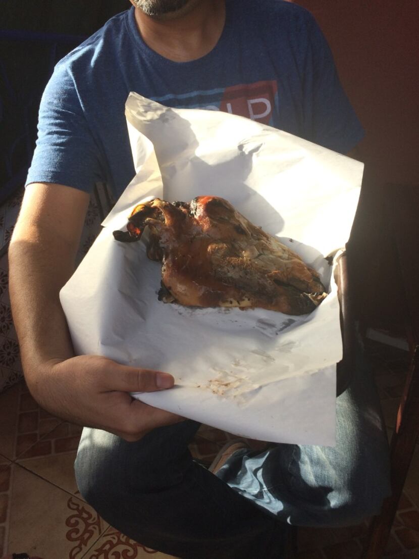Our Marrakesh food tour guide, Youssef Mouttaki, holds the roasted sheep's head. 