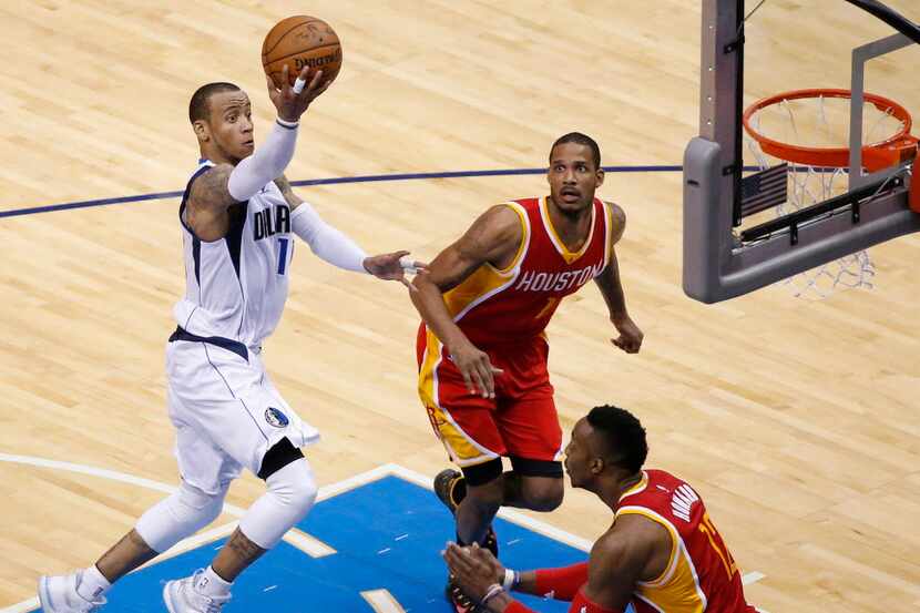 Dallas Mavericks guard Monta Ellis drives to the basket by Houston Rockets forward Trevor...