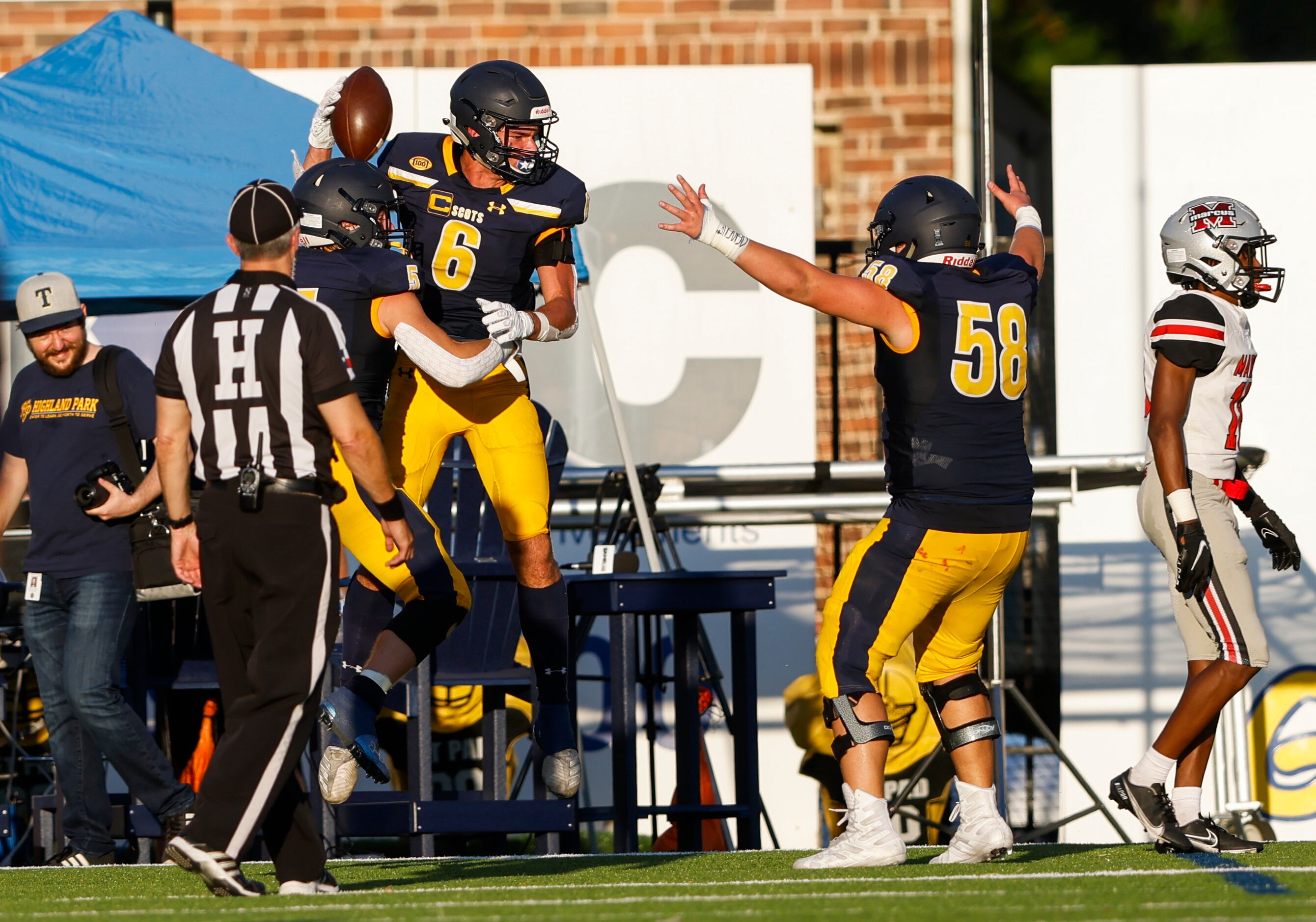 Highland Park wide receiver Luke Herring (6) celebrates with teammates in the end zone after...