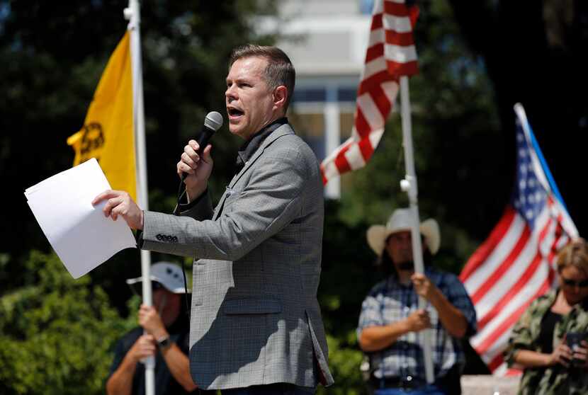Attorney Warren Norred spoke during a Texas Freedom Force protest over the  removal of the...