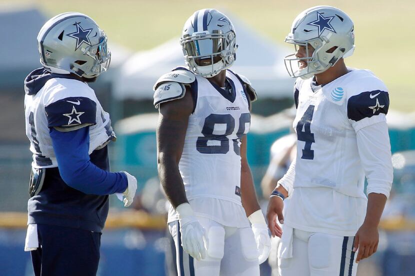 Dallas Cowboys quarterback Dak Prescott (4) talks with Dallas Cowboys wide receiver Dez...