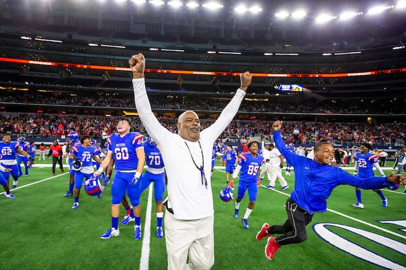 Duncanville coach Reginald Samples leads the celebration as Panthers players charge the...