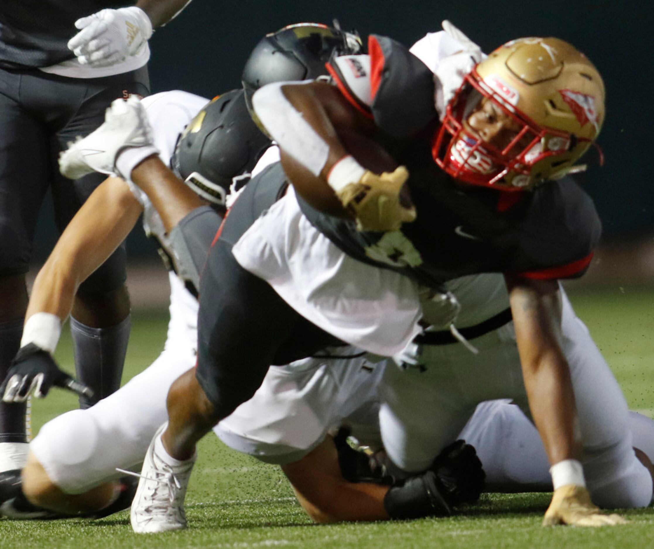 South Grand Prairie running back Deamikkia Nathan (8) lunges for extra yardage after taking...