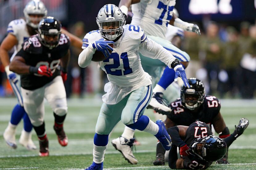 Dallas Cowboys running back Ezekiel Elliott (21) breaks away from defenders Atlanta Falcons...