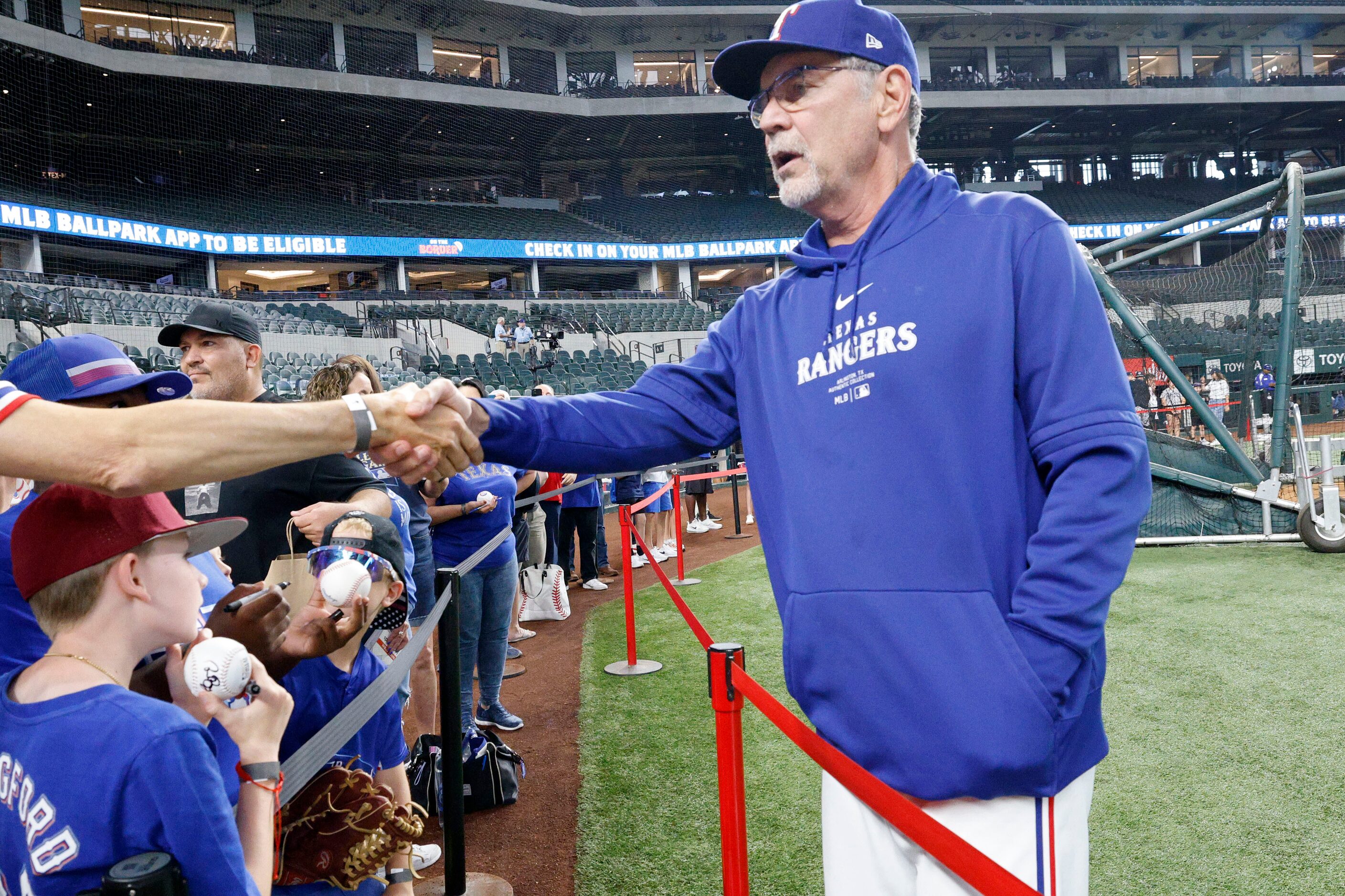 Texas Rangers manager Bruce Bochy (15) greets fans before a baseball game against the New...