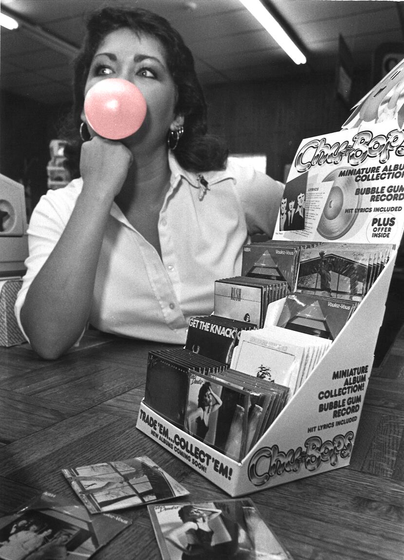 Lyddie Cooper, 20, cashier at Peaches Records blows bubbles and waits for costumers - Sept 1980