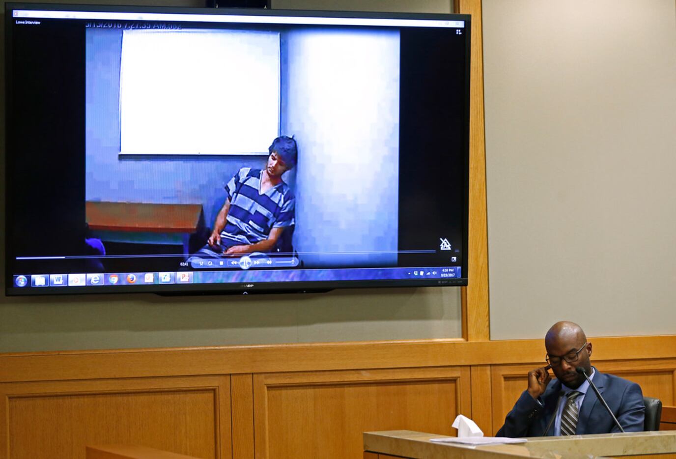 Richardson Police Detective Chiron Hale testifies as prosecution plays a video of a jail...