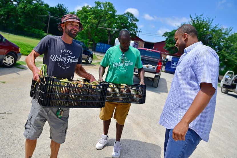 Demler and Horton deliver freshly picked onions to Donald Wesson, program director of...