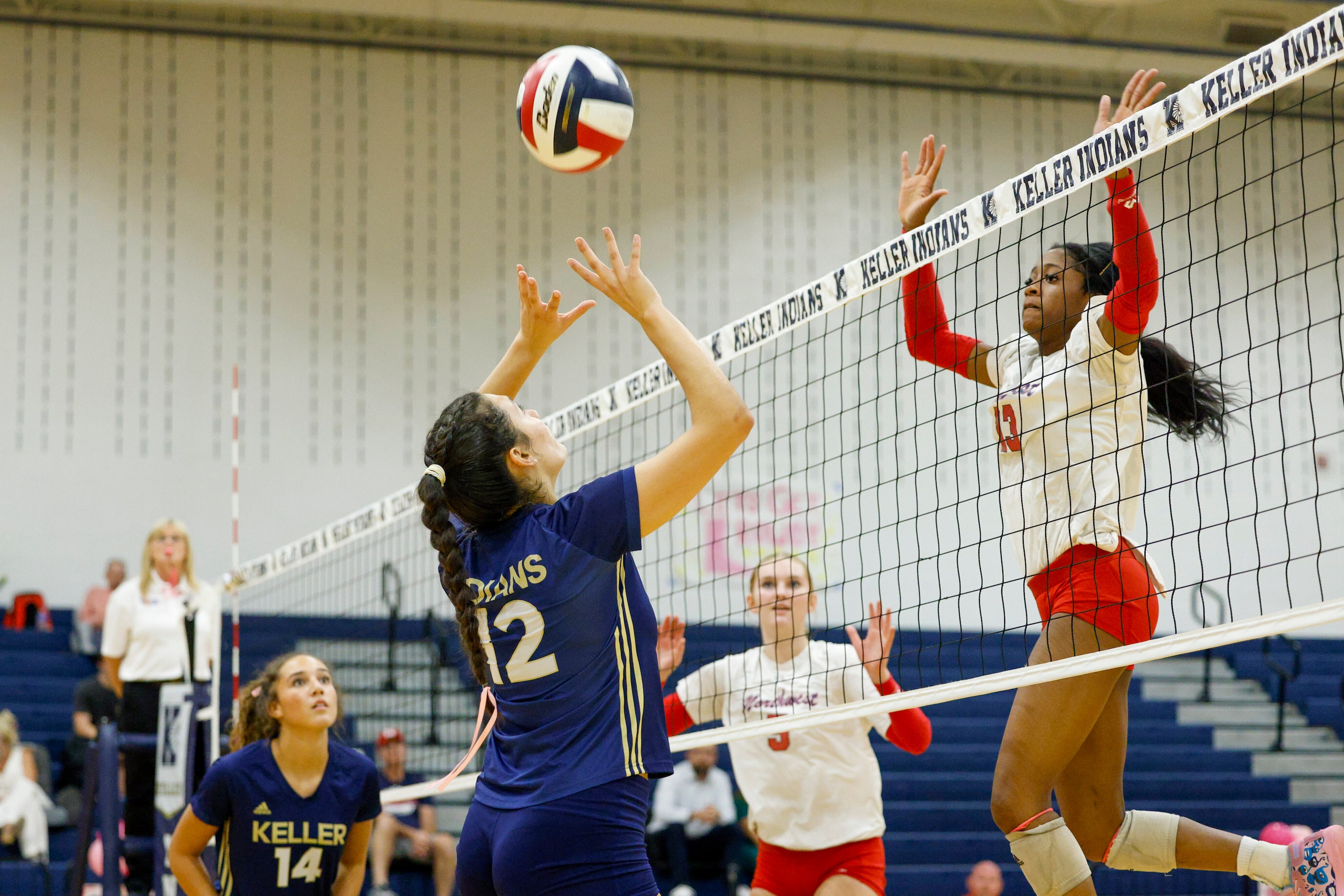 Justin Northwest's Levariya Pinder (13) jumps to block a pass from Keller's Anna Flores (12)...