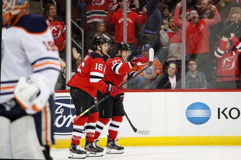 Edmonton Oilers goaltender Mikko Koskinen (19) skates away as New Jersey Devils center Kevin...