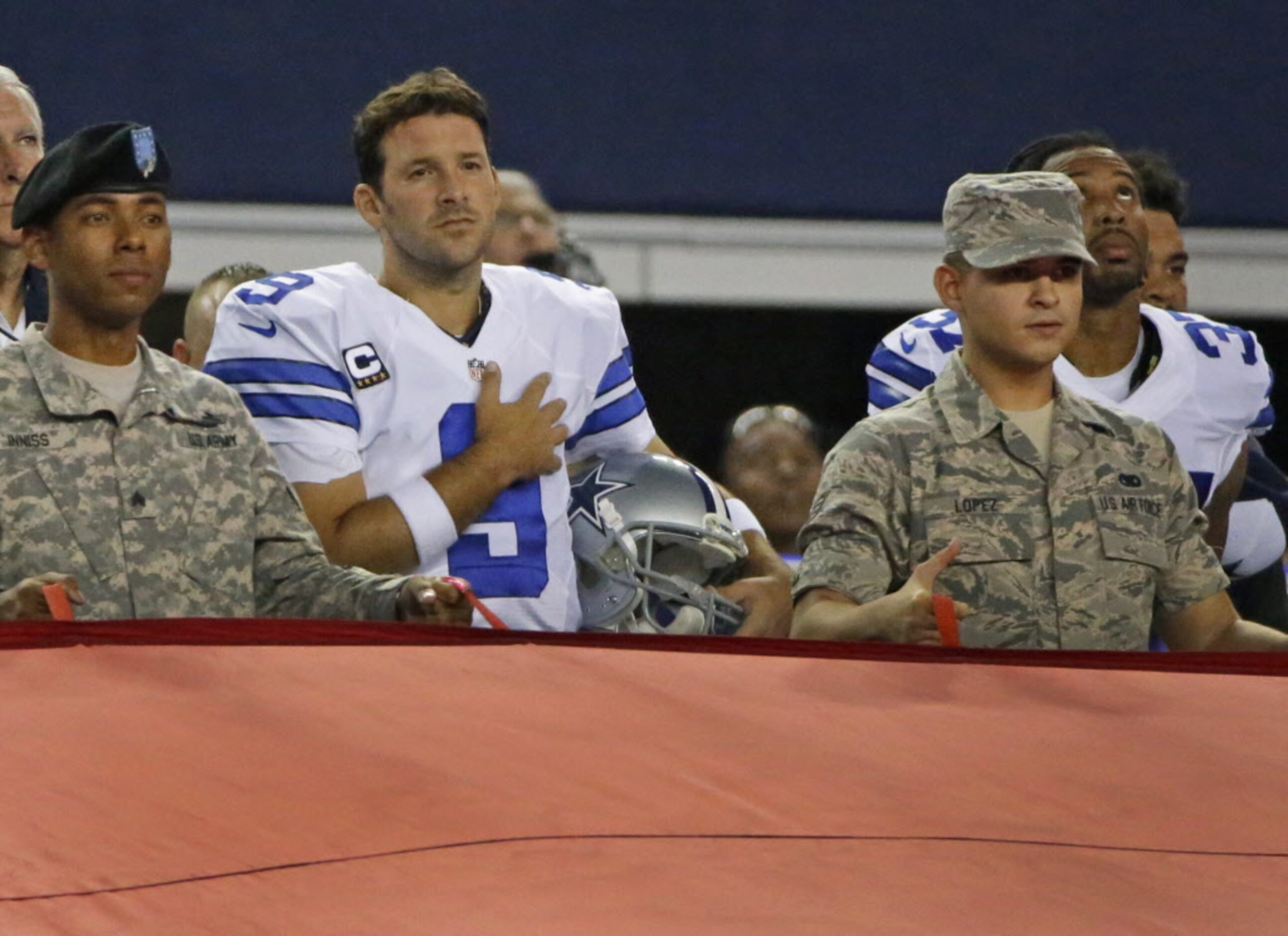 Dallas Cowboys quarterback Tony Romo (9) stands during the National Anthem during the...