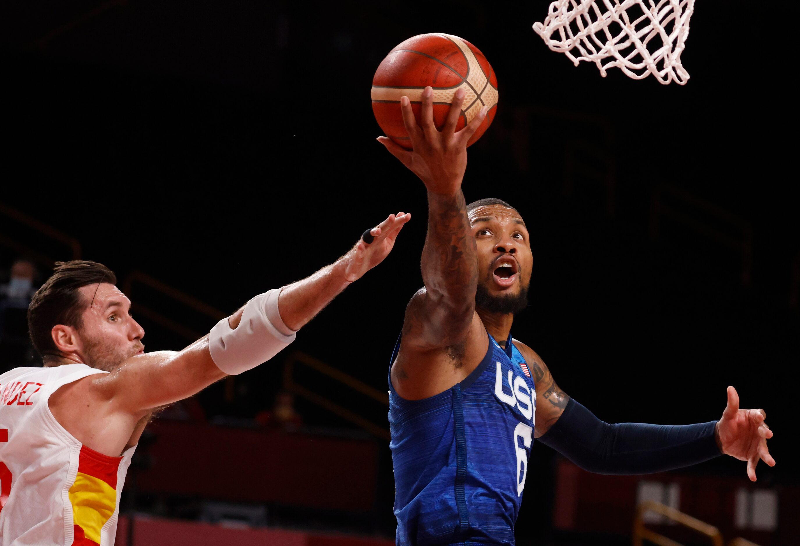 USA’s Damian Lillard (6) attempts a layup in front of Spain’s  Rudy Fernandez (5) during the...