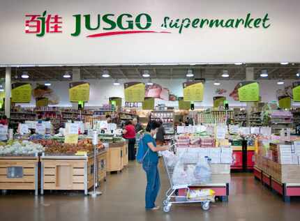 Shoppers in the Jusgo Supermarket, which is owned by a company based in Taiwan and caters to...