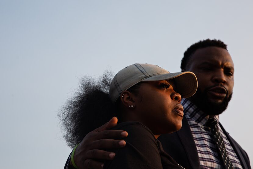 LaChay Batts and her family's attorney Lee Merritt speak to the media outside the Collin...