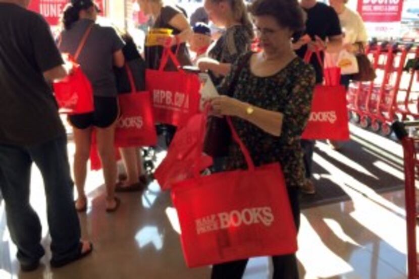  Customers check for gift cards in their free totes.