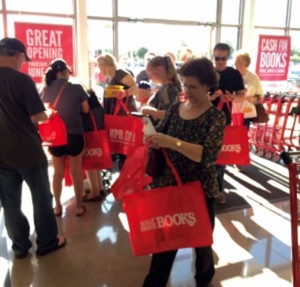  Customers check for gift cards in their free totes.