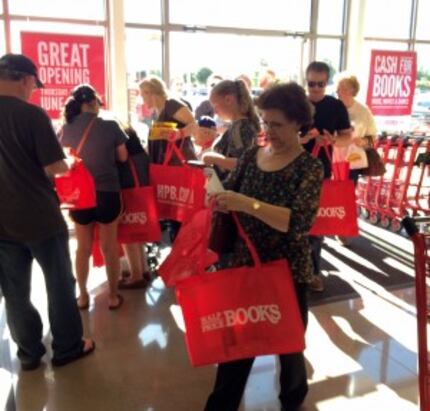  Customers check for gift cards in their free totes.
