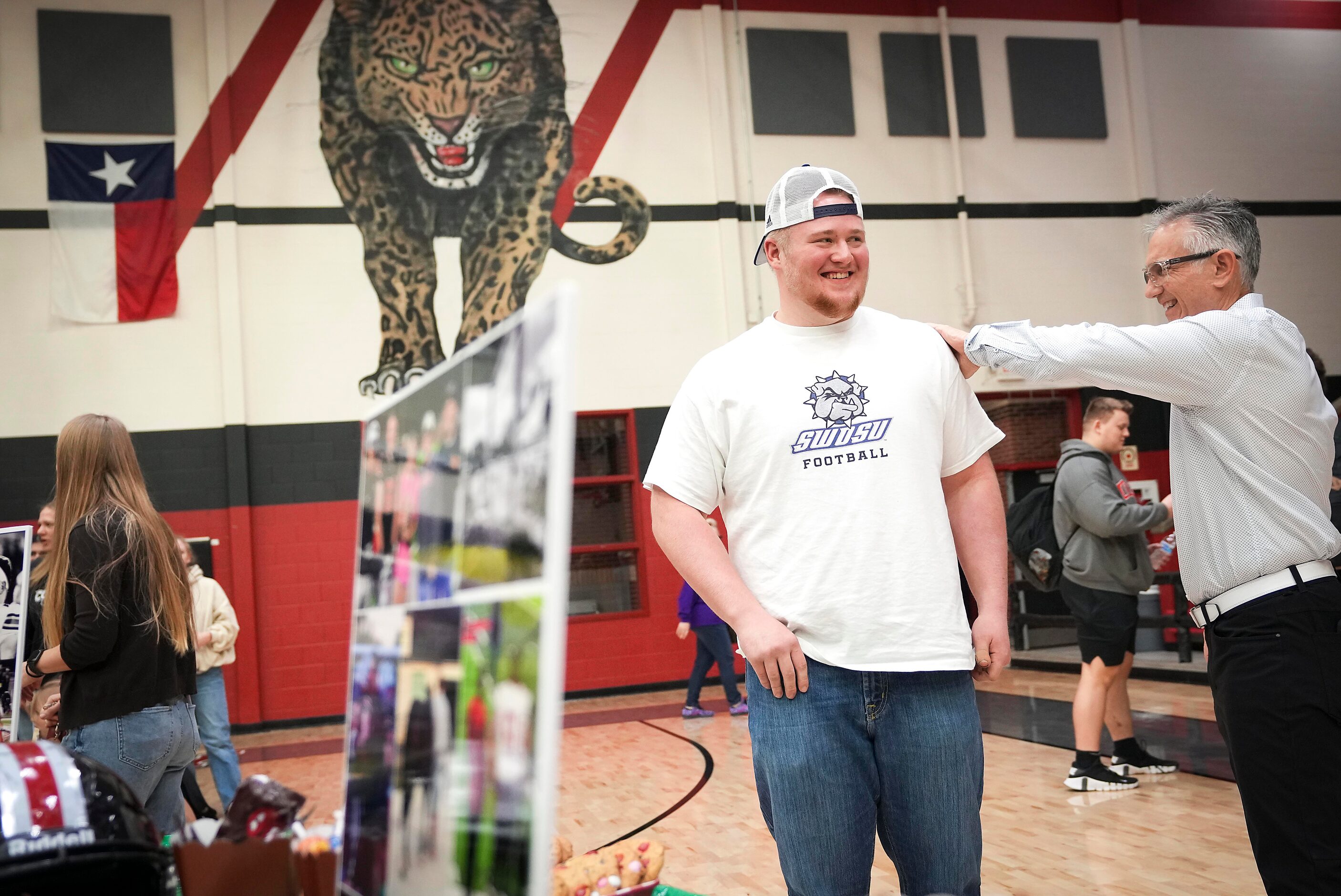 Lovejoy all-state offensive lineman Sam Reynolds is congratulated by a coach during a...