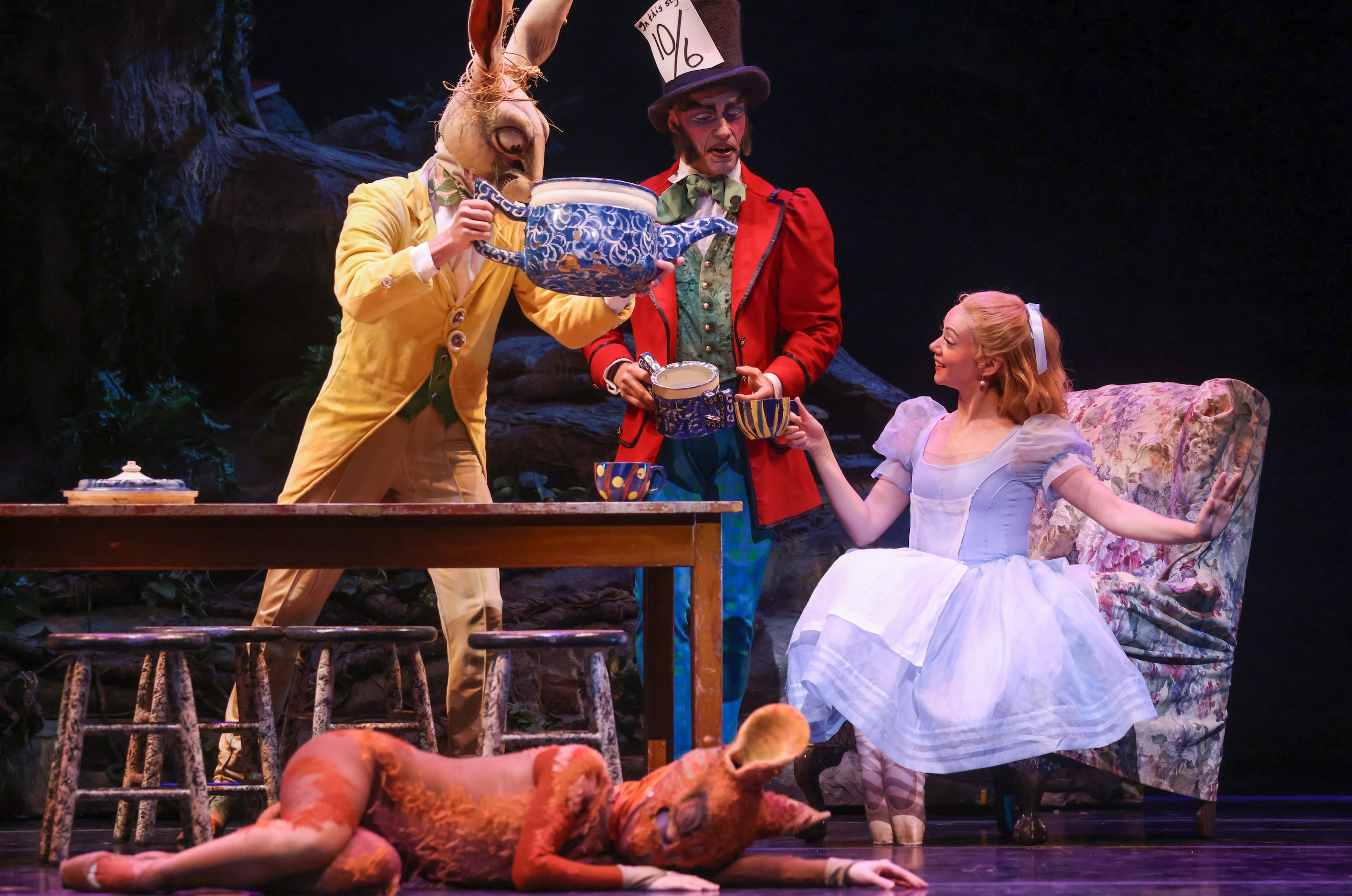 The March Hare (Carl Cooper, left), and Mad Hatter (Alexander Kotelenets) serve Alice...