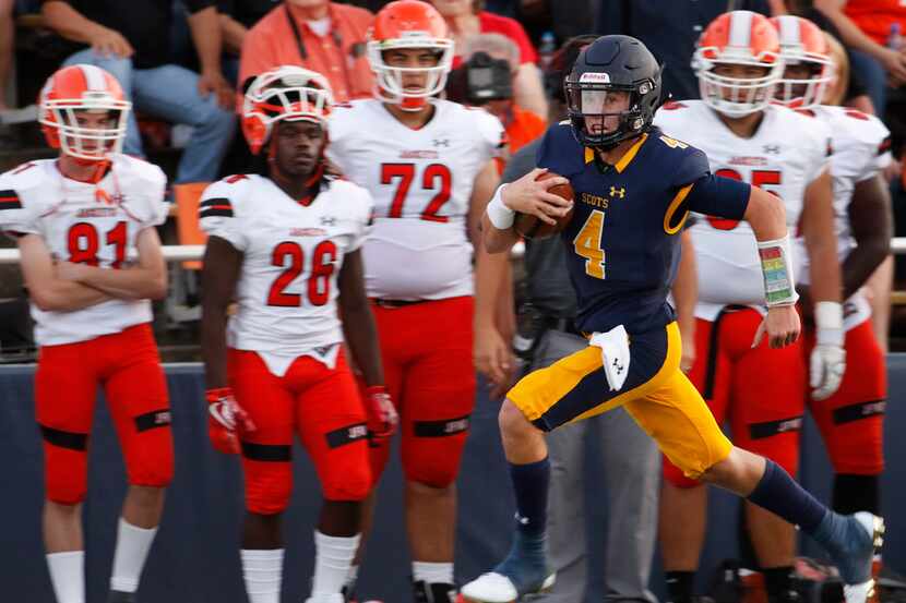 Highland Park quarterback Chandler Morris (4) races past the dismay of the Rockwall bench...