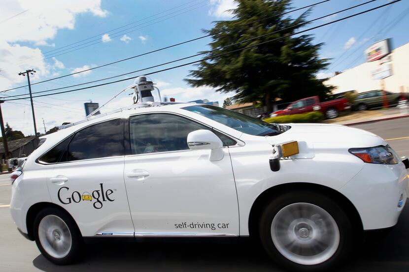 Google's self-driving Lexus car drives along street during a demonstration at Google campus...