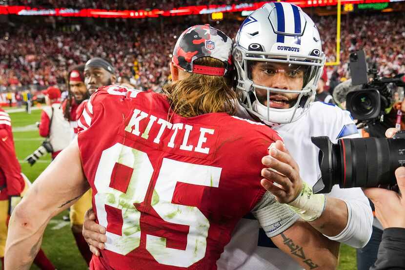 Dallas Cowboys quarterback Dak Prescott (4) hugs San Francisco 49ers tight end George Kittle...