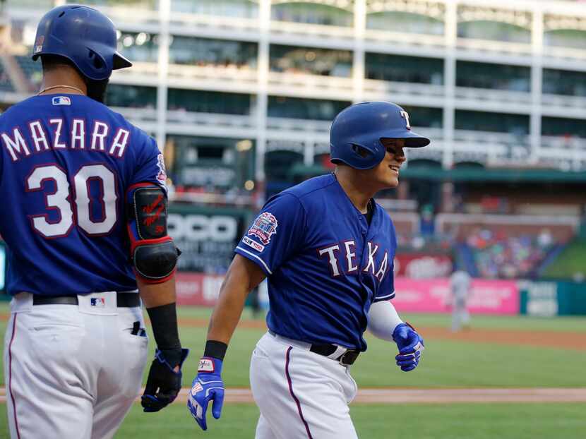 FILE - The Rangers' Shin-Soo Choo (17) smiles after Nomar Mazara (30) congratulated him for...